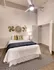 Model Tobacco Lofts bedroom with large closet, and a ceiling fan above.