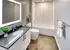 Remodeled bathroom with large vanity and tub shower combo at Model Tobacco Lofts.