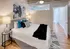 Serene bedroom with bed, nightstands, and a charming painting at Model Tobacco Lofts.