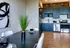 A sleek black table surrounded by elegant white chairs, creating a stylish and contrasting dining area at Model Tobacco Apartments.
