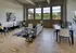 Model Tobacco living room with beautiful hardwood floors and large windows, inviting natural light to fill the space.