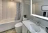 Elegant bathroom with modern backlit mirrors at Model Tobacco Lofts in Richmond.