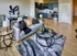 Model Tobacco living room with a comfy couch, a stylish coffee table, and a modern kitchen nearby.