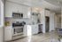 Modern kitchen with sleek stainless steel appliances, elegant white cabinetry, and tasteful decor, perfect for contemporary living.