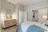 Inviting bedroom with a cozy bed, elegant dresser, and ample closet space, perfect for relaxation and comfort.