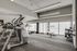 Modern fitness center featuring advanced cardio equipment, a punching bag, and a variety of exercise balls for a comprehensive workout experience.