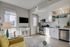 Modern open-concept living space with elegant kitchen, cozy seating, and abundant natural light.