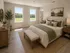 Elegant bedroom with large windows showcasing a scenic view, featuring a cozy bed with stylish green accents and chic wooden furniture.