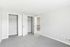 Bright, spacious bedroom with plush carpeting and double closets, perfect for modern living.