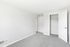 Bright, freshly painted room with plush carpeting and spacious closet, perfect for a cozy retreat.