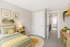 Charming kids' bedroom with sun-themed decor, playful dinosaur artwork, and cozy atmosphere.