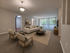 Inviting living room with modern decor, cozy seating, and large windows bringing in natural light.