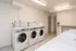 Modern laundry room with advanced commercial washers in a sleek and clean environment, perfect for convenient apartment living.