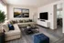 Inviting living room with plush sectional sofa, modern decor, and serene wall art, ideal for relaxation and entertainment.