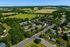 Charming aerial view of a serene residential community surrounded by lush greenery, showcasing peaceful living in a picturesque landscape.