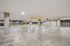 Spacious and well-lit parking garage with marked parking spaces and modern concrete pillars.