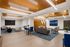 Modern apartment common area with stylish seating, sleek furniture, and warm wood accents; ideal for relaxation and social gatherings.
