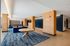 Modern lobby interior at West End Place, featuring elegant wood paneling, blue accents, and cozy seating areas with plush sofas.