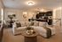 Inviting open-plan living area featuring a modern kitchen, plush sectional sofa, and elegant dining space with natural lighting.