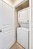 Compact laundry area featuring a modern stacked washer and dryer for convenient in-home laundry care.