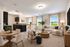 Inviting open-concept living area featuring elegant furnishings, a cozy dining space, and a sleek modern kitchen with a serene outdoor view.
