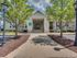 Tree-shaded sidewalk leading up to buildings at The Landings at Chandler Crossings | Student Housing Near Michigan State University