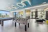 Vibrant communal space with foosball and billiards tables, cozy seating area, and modern design elements for social gatherings.