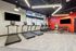 Modern fitness center with sleek treadmills, weight racks, and vibrant red accents, perfect for an energizing workout.
