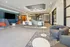 Modern lounge area featuring stylish seating, a sleek kitchen counter, and dynamic lighting fixtures.