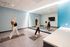 Modern exercise area with vibrant wall patterns and large mirrors, showcasing a serene yoga session.
