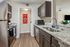Sleek and modern kitchen with stylish granite countertops and stainless steel appliances, offering a warm and inviting atmosphere.