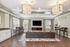 Modern living room with elegant lighting, featuring a cozy leather sofa, sleek floor-to-ceiling windows, and neutral decor. Perfect space for relaxation and entertainment.