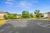 Inviting outdoor basketball court surrounded by lush greenery and modern apartment buildings under a bright blue sky.