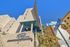 Stunning modern apartment building with sleek architecture, featuring a vibrant blue sky background and natural stone facade, located at Topaz and Montezuma.