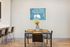 Chic dining area with elegant table set, stylish seating, and vibrant decor, adjacent to modern kitchen with breakfast bar.