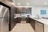 Modern U-shaped kitchen with dark wood cabinets, stainless steel appliances, and sleek countertops, ideal for culinary creativity.