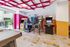 Vibrant arcade room with classic pinball and video games, featuring colorful decor and modern design for entertainment enthusiasts.