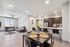 Contemporary open-concept apartment with a bright living room and sleek kitchen, featuring stylish decor and panoramic views.