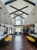 Inviting apartment lobby with vaulted ceilings, elegant decor, and a cozy seating area.