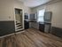 311 south 41st street kitchen area with stove, microwave, and dishwasher; hardwood flooring and back staircare.