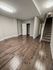 4036 locust street house entry and living area with hardwood floor and staircase to second floor