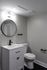 4029 walnut street unit 19 renovated philadelphia university city. bathroom with toilet, sink vanity, and mirror.