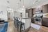 tenn student living knoxville model unit kitchen with island and stools and stainless steel appliances