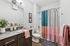 tenn student living knoxville mode unit bathroom with sink, toilet, and shower tub.