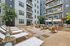 tenn student living knoxville exterior courtyard area with lounge seats. tables, umbrellas, and grills.