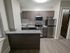4111 walnut street philadelphia renovated kitchen with granite countertops, an stainless steel appliances. stove, refrigerator, microwave
