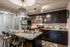 Modern kitchen with sleek dark cabinetry, stainless steel appliances, and elegant island seating for four under stylish pendant lighting.