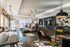 Luxurious and spacious lounge area featuring modern furniture, stylish pendant lighting, and a sleek bar setup, perfect for relaxing or entertaining.