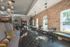 Chic and inviting communal lounge with plush seating, exposed brick walls, and modern lighting fixtures enhancing a cozy atmosphere.