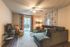 Inviting living room with cozy sectional sofa, stylish decor, and a warm ambiance, perfect for relaxation.